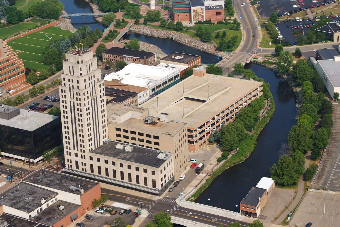 Aerial view of downtown Battle Creek, with the Art Deco tower beside the river and a parking structure